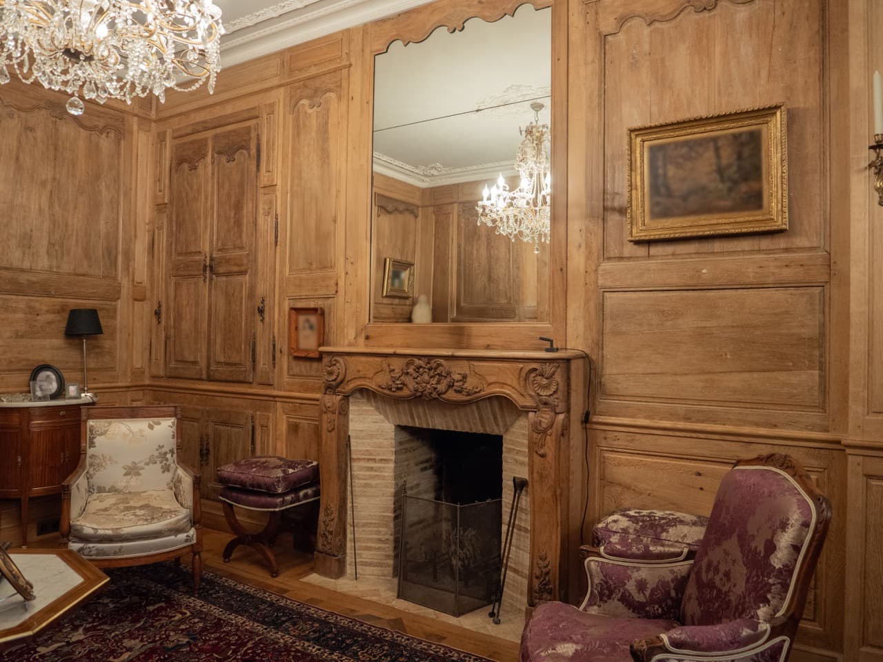 Salon entièrement lambrissé de chêne avec cheminée
