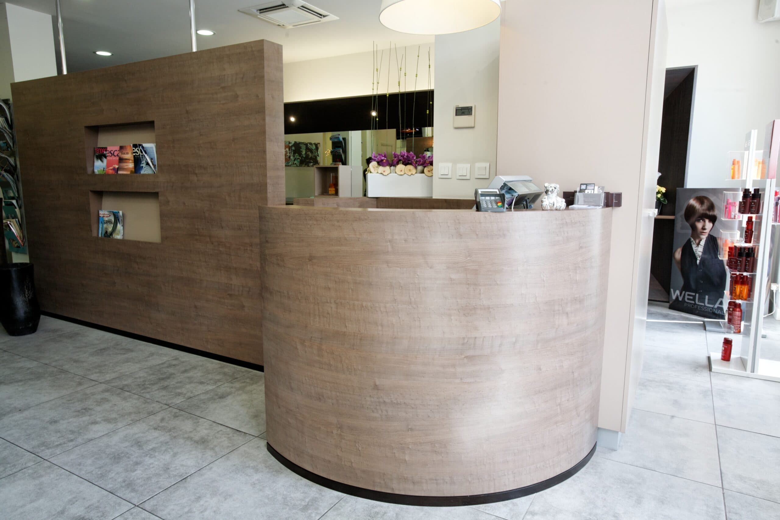 Comptoir de réception en bois cintré d'un salon de coiffure