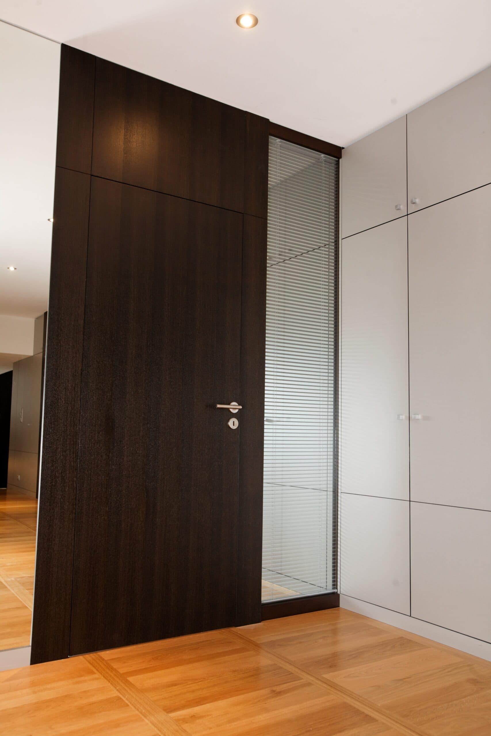Porte en bois foncé toute hauteur avec bande vitrée